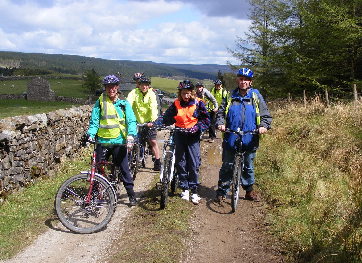 A group of people on bicycles in the countryside