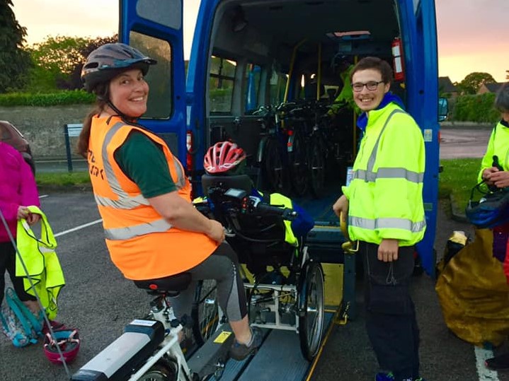 Two people at the back of a minibus