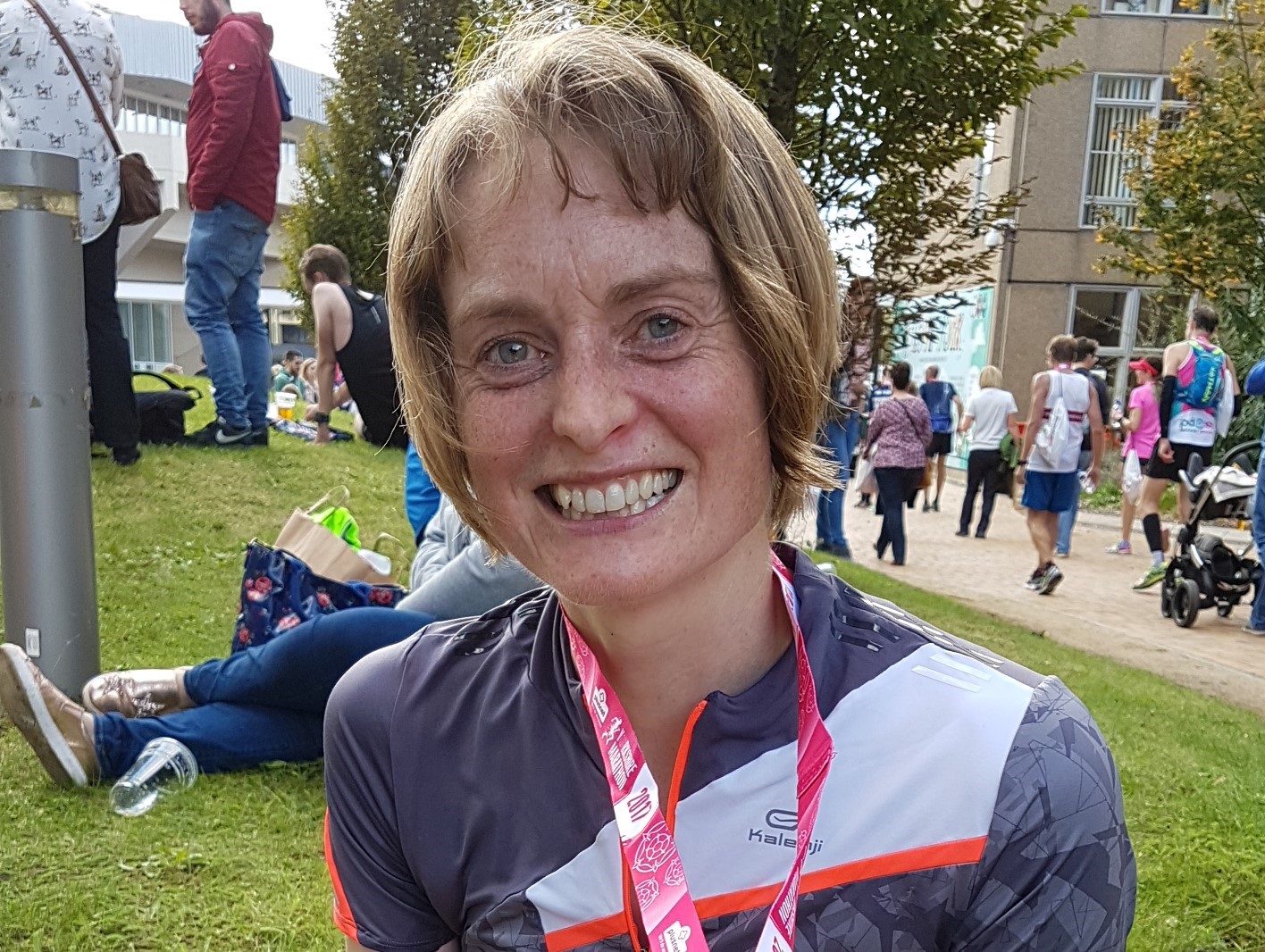 A woman smiling at the end of the marathon