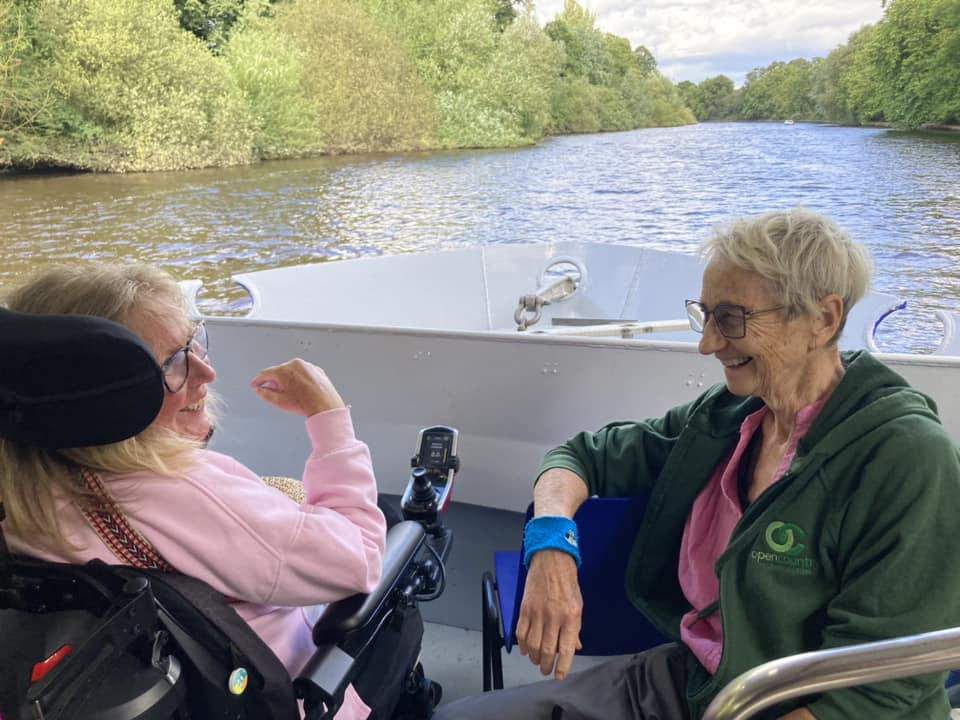 Two women sitting and chatting on a boat