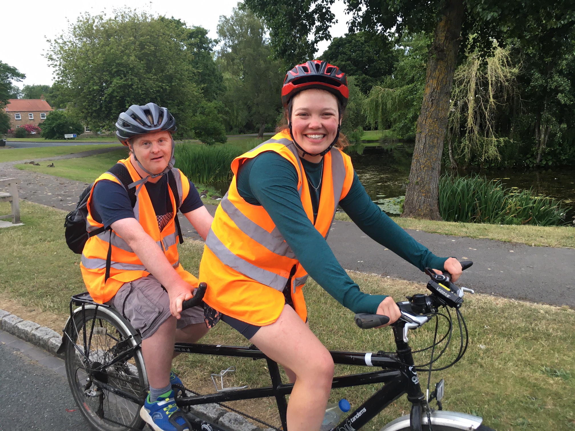 A man and woman on a tandem bike