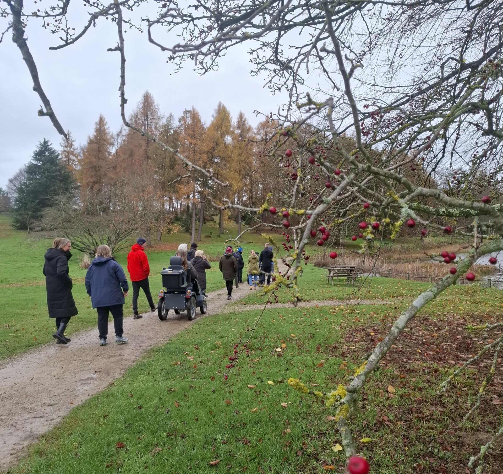 A group of people walking on a path in the countryside